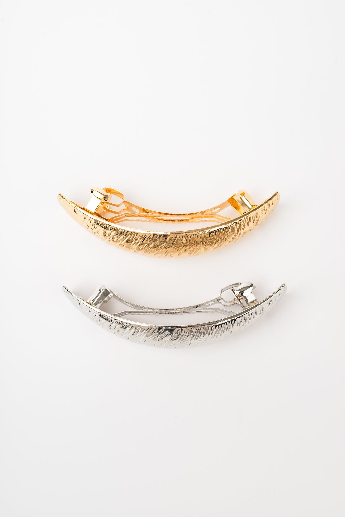 Gold and silver textured barrettes showing clasp backs