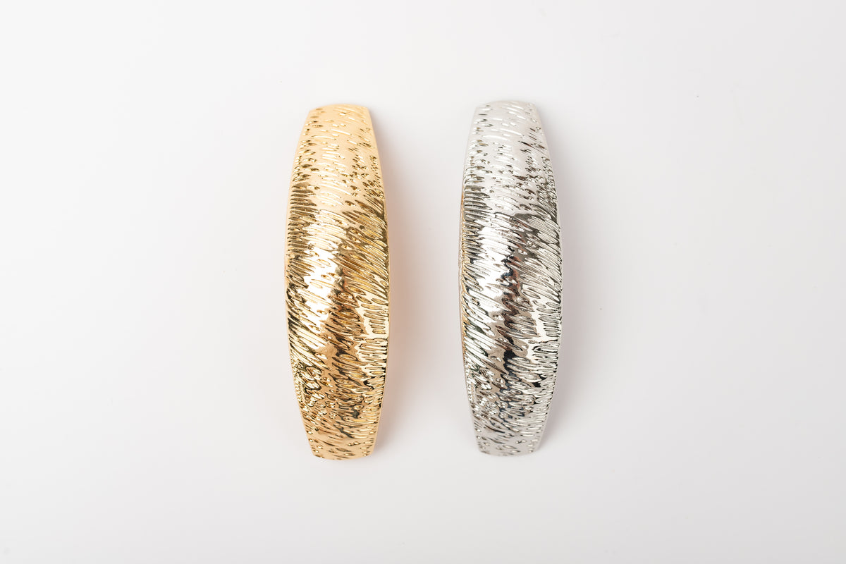 Gold and silver textured barrettes together without packaging