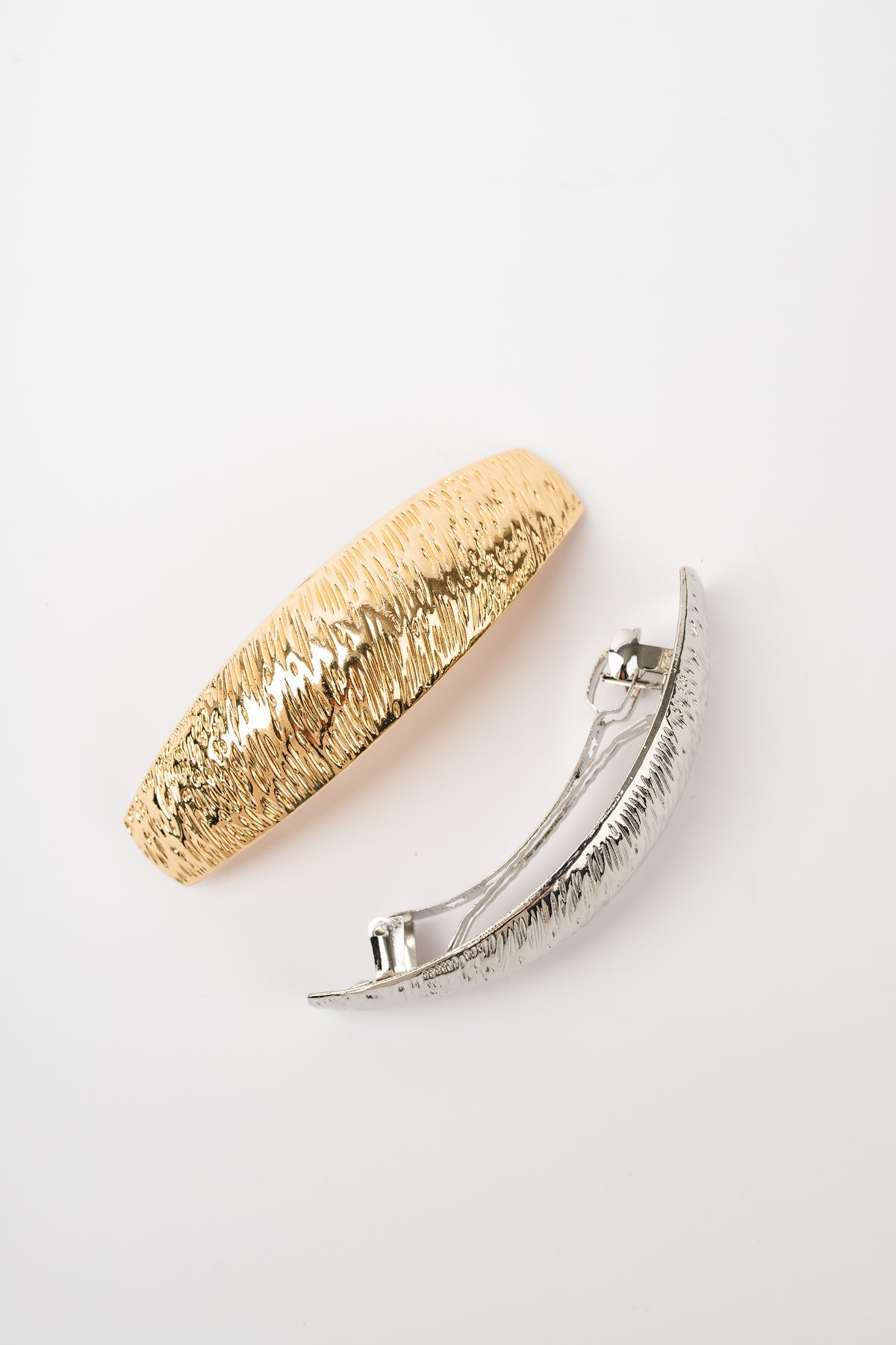 Gold and silver textured barrettes close-up