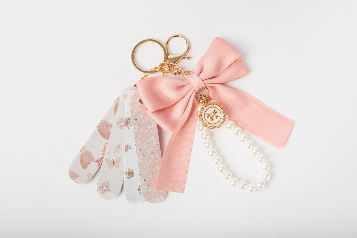 Coquette mini nail file keychain set COQ201, photographed outside its packaging to show the files and charms