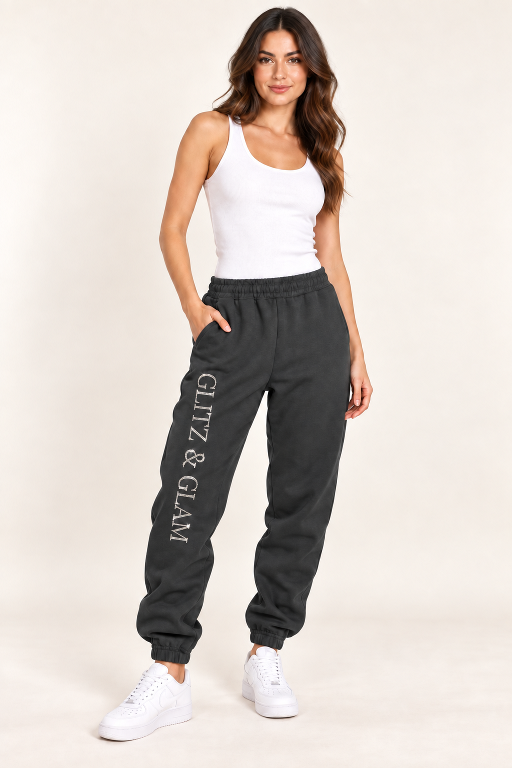 Model wearing Glitz & Glam cuffed joggers in black; logo placement matched to side slit joggers