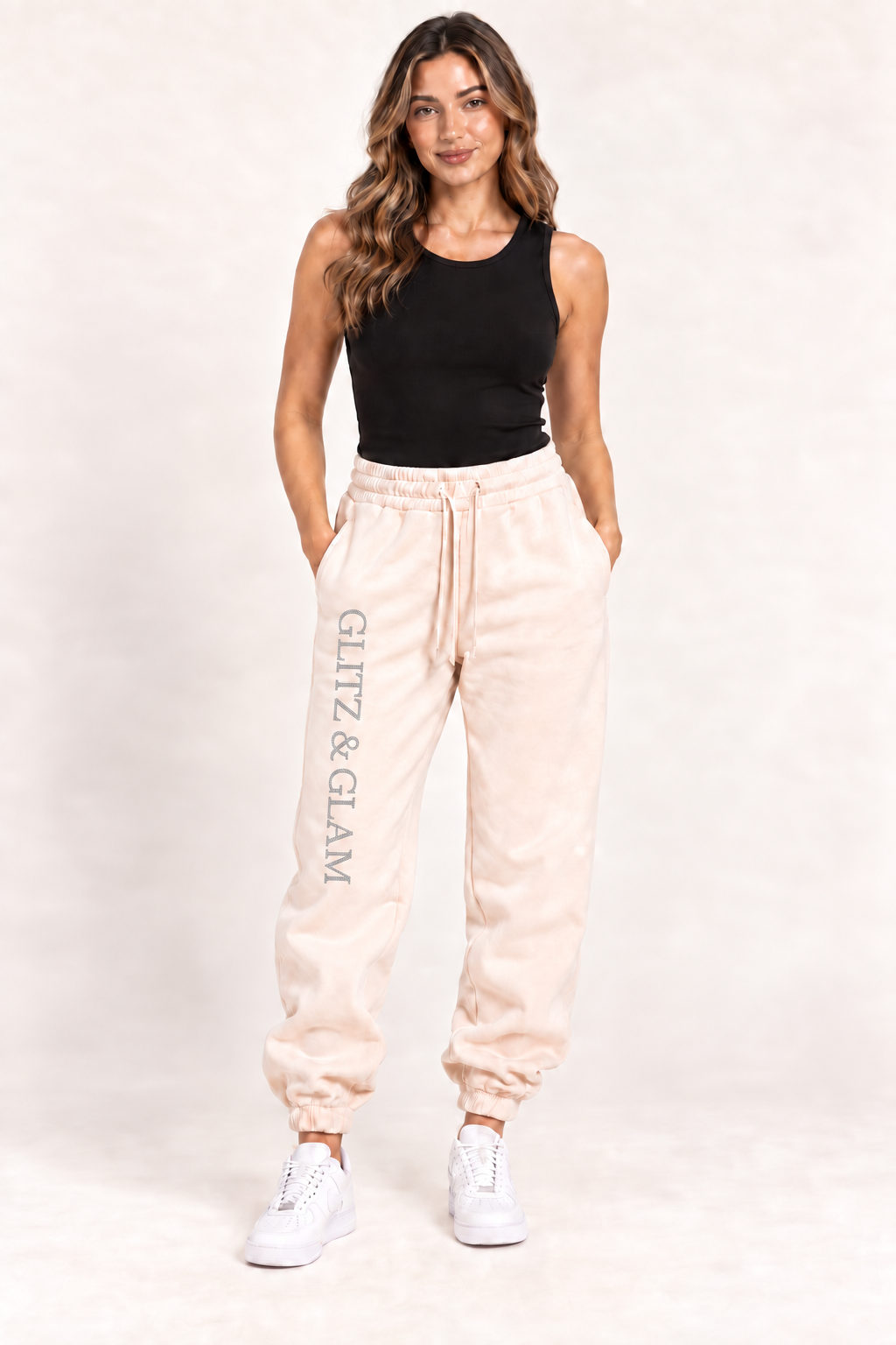 Model wearing Glitz & Glam cuffed joggers in champagne; logo placement matched to side slit joggers