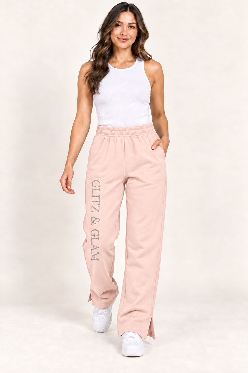 Model wearing Glitz & Glam open leg joggers in pink, correctly oriented logo